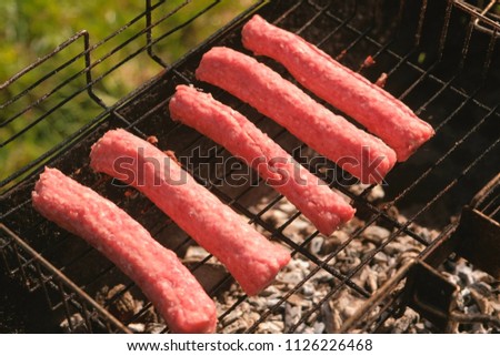 Sausages are fried on the grill.