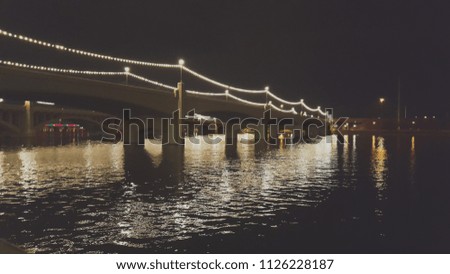 Tempe Town Lake Bridge lights glistening off the water below