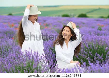 young woman and girl are in the lavender field, beautiful summer landscape with red poppy flowers