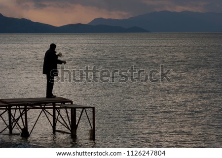 Silhouette image of  a man at the beach before sunset background