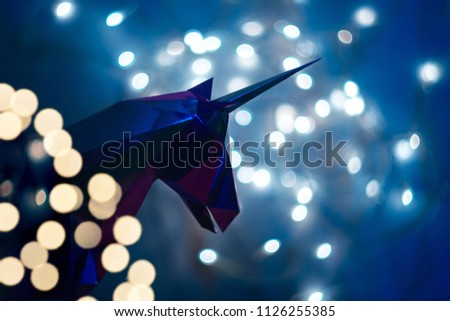 Fantastic photo of the silhouette of a unicorn on the background of a bokeh from the lights