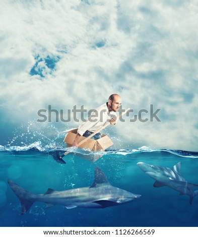 Escape from crisis concept with a businessman on a cardboard Royalty-Free Stock Photo #1126266569