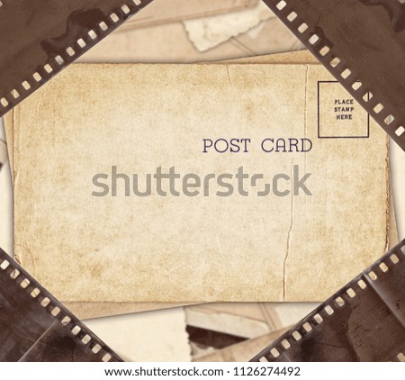 Vintage background with aged retro postcard and old film strip