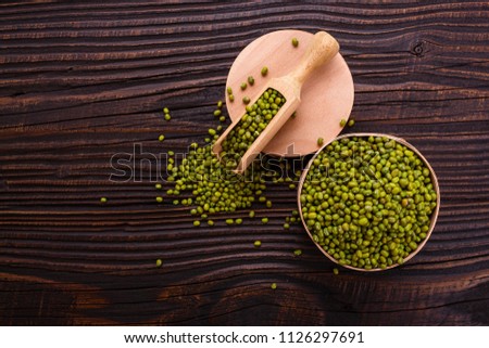 fresh Mung beans on a rustic wooden background