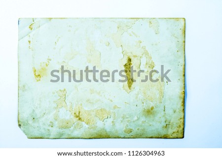 Old photo texture with stains and scratches. Vintage and antique art concept. Front view of blank old aged dirty frame with stains isolated on a white background. Detailed closeup studio shot.