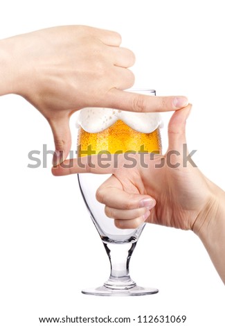 Glass of beer with two women hands making frame. love beer concept