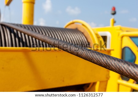Wire rope sling or cable sling on crane reel drum  or winch roll of crane the lifting machine in heavy industrial Royalty-Free Stock Photo #1126312577