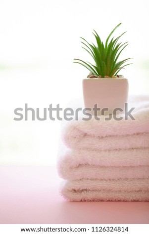 Spa. White Cotton Towels Use In Spa Bathroom on Pink Background. Towel Concept. Photo For Hotels and Massage Parlors. Purity and Softness. Towel Textile.