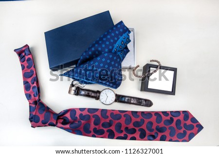Men accessory, Arm button, navy blue cowl, tie, wrist watch, handkerchief, bracelet, socks.