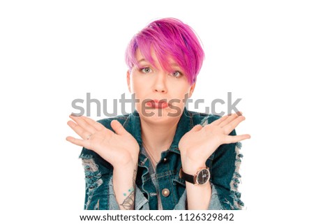 Closeup of emotional upset young woman isolated on white background being at a loss, showing helpless gesture with arm and hands, mouth curved as if she does not know what to do with current situation