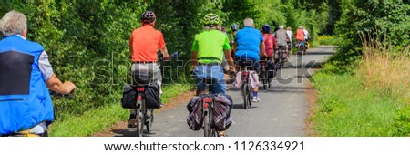 Cyclists in the forest. A group of cyclists riding on the road, banner