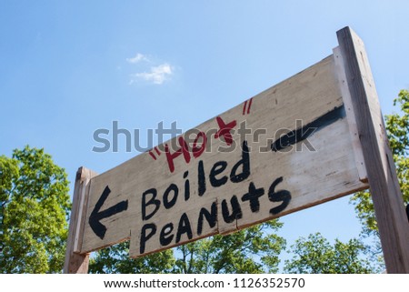 Sign points toward the sale of hot boiled peanuts at an antique festival in Braselton, GA. 