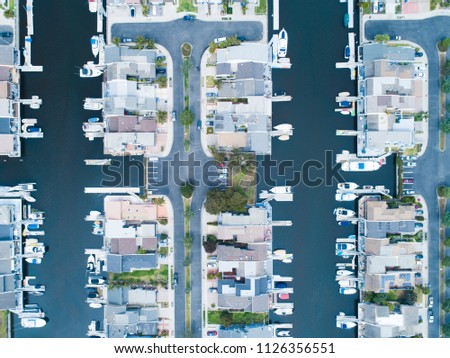 Aerial shooting of a luxury resort town on the waterside.
A villa with a private boat.