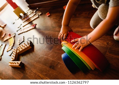Children playing with wooden rainbow waldorf montessori