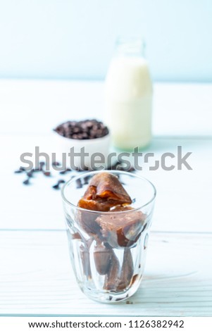 coffee ice cubes with milk on wood table