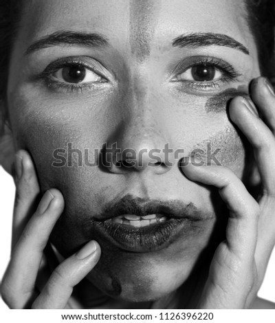 Close-up face of young woman with the lipstick smeared over the face. State of nervous or post depression syndrom. Ideal image for the articles for psychologists. Black and white photo.