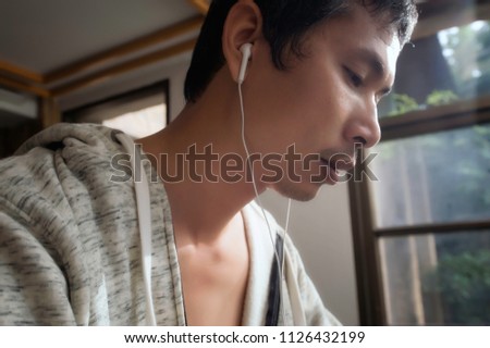 Portrait Of Male Jogger Standing In Fitness While Listening Music