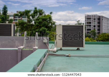 HVAC Air Chillers on Rooftop part,Air compressor machine unit of air conditioner system on roof of building on town background