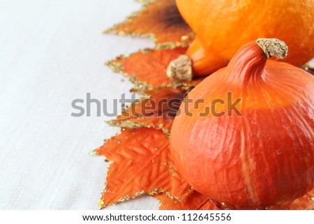 Autumn arrangement with Hokkaido pumpkins and colorful leaves