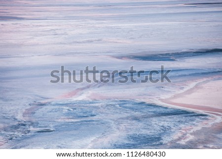 Salty lake with patterns similar to the surface of Mars, Saturn, Earth or other planets from outer space
