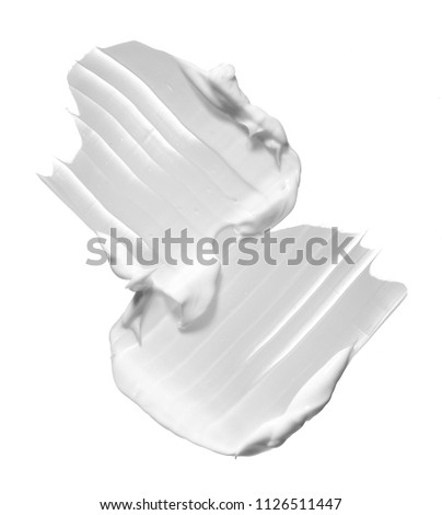 White smear of cosmetic cream isolated on white background. White creamy foundation texture isolated on white background