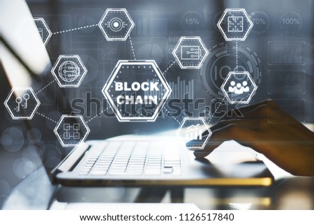 Blockchain with hand typing on a laptop outdoors.