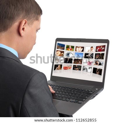 man looking some pictures on the laptop