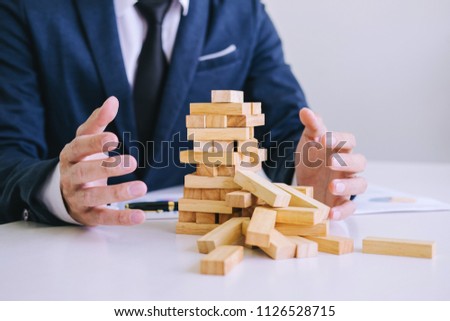 Alternative risk concept, plan and strategy in business protect with balance wooden stack with hand control risk shape. Royalty-Free Stock Photo #1126528715