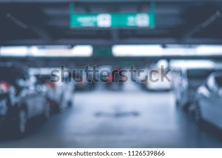 Blurry of car parking lots at department store. Abstract and transportation concept. Dark and low key tone