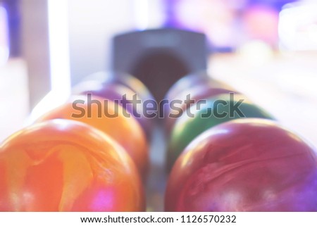 Multicolored bowling balls arranged in a row. Vivid colors. Summer day,