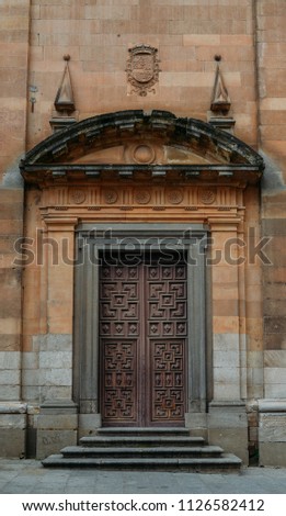 Baroque-style wooden door to a church in the historic centre of Salamanca, Spain.