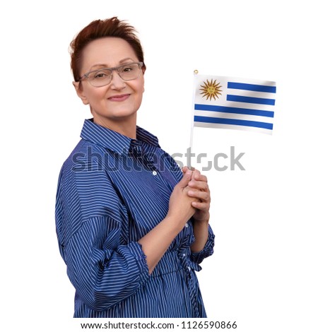 Uruguay flag. Woman holding Uruguayan flag. Nice portrait of middle aged lady 40 50 years old with a national flag isolated on white background.