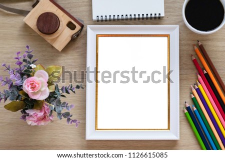 Top view of template white frame mockup with copy space, decorated with flower, wooden camera, black coffee, clock and note book for wedding concept