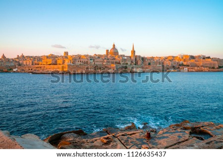 Panoramic view of Valletta Skyline at beautiful sunset from Sliema with churches of Our Lady of Mount Carmel and St. Paul's Anglican Pro-Cathedral, Valletta, Capital city of Malta