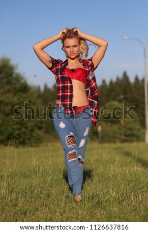 girl in plaid shirt in a field
