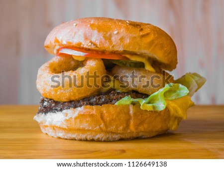 Delicious and juicy burger with appetizing meatball and fresh vegetables