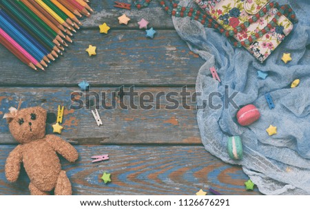 Children frame with toy, pencils, paper stars, teddy bear. Kids zone concept. Place for text.