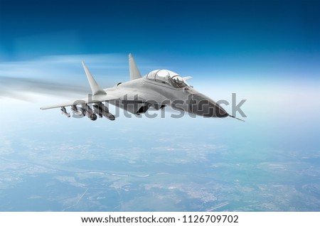 Fighter jet fly hight speed combat mission above the clouds Royalty-Free Stock Photo #1126709702