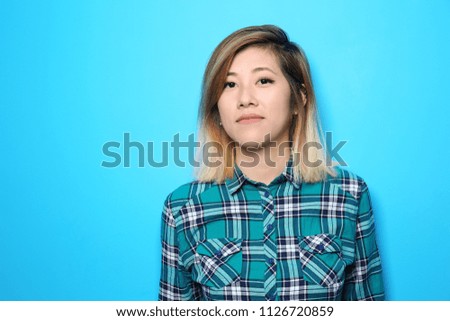Portrait of beautiful Asian woman on color background