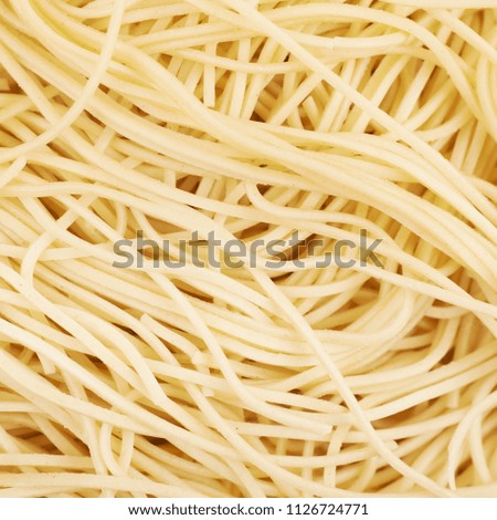 Surface coated with the cooked noodles, close-up fragment as a backdrop texture compositions