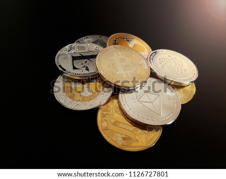 Stack of cryptocurrencies Bitcoin BTC Ripple XRP Ethereum ETH IOTA Litecoin LTC Steem Dash on a black background with light from above