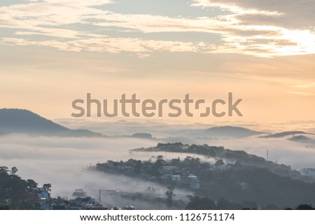 Sky and landscape in fog at the dawn