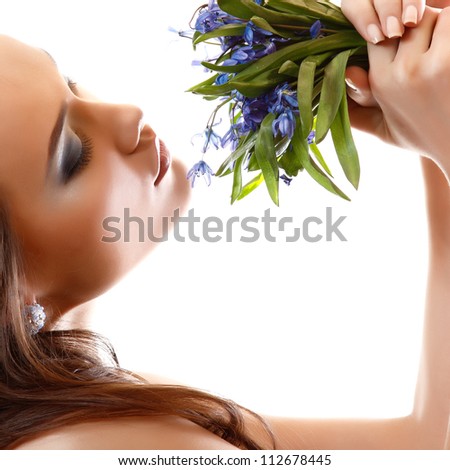 Beautiful teen girl smell and enjoy fragrance of snowdrop flowers. isolated on white background