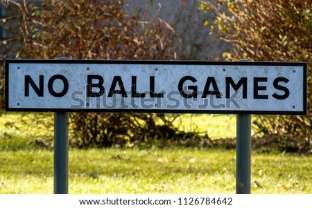 A sign 'No Ball Games' in the centre of a Scottish town