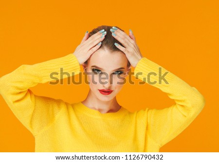 Colorful makeup woman red lips in yellow clothes on color happy summer fashion background manicured nails