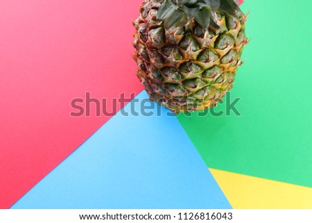 Pineapple on a multi-colored background, tropical fruit top view, pineapple in pop art style, vegetarian food in minimalism style, copy space
