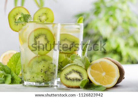 tropical cocktail with kiwi, lemon and mint on light background Royalty-Free Stock Photo #1126823942