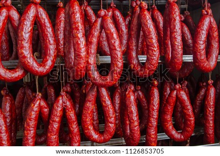 Sausage. Sausage production line. Sausage on the counter for the smokehouse. Industrial manufacture of sausages. Royalty-Free Stock Photo #1126853705