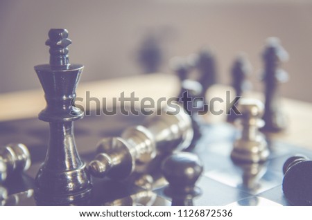 Detail of a hand making the first move in a chess game, moving the pawn one field forward. Selective focus