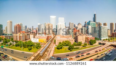 Downtown cityscape with elevated train and traffic. Panorama. West Loop, Chicago, USA. Interstate 90 at Lake Street. 